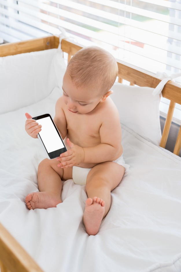 baby-boy-playing-with-mobile-phone-on-a-cradle_1170-480